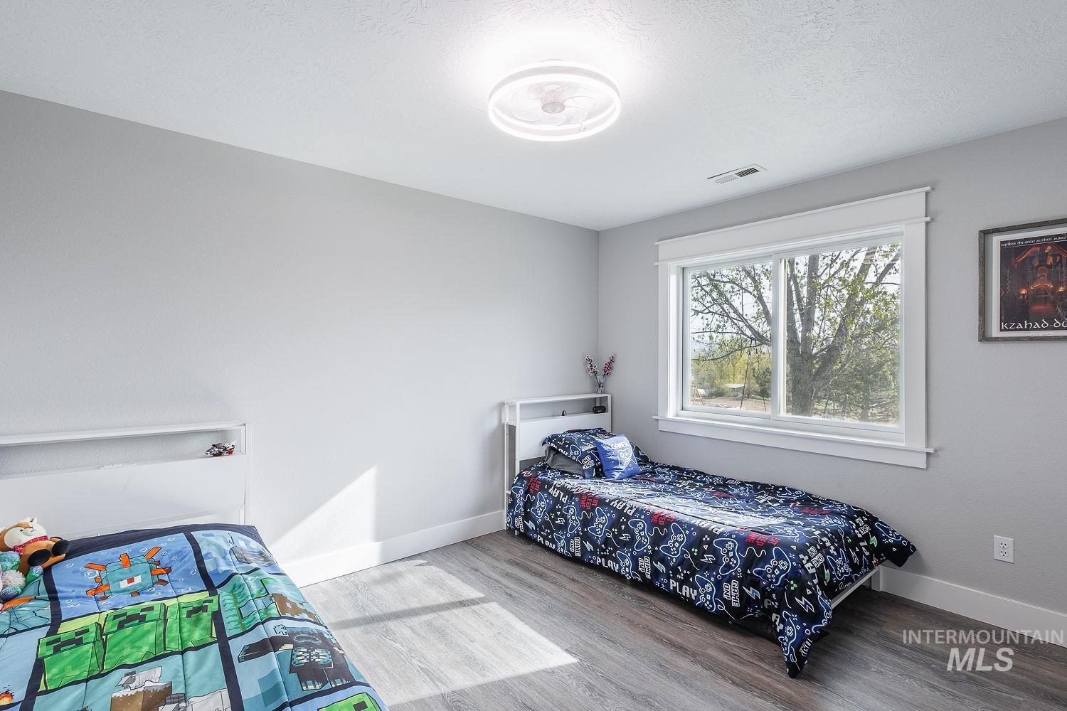 3950 Cassia Road New Plymouth, ID 83655 - Photo 21 of 26 Bedroom with light wood-type flooring and baseboards