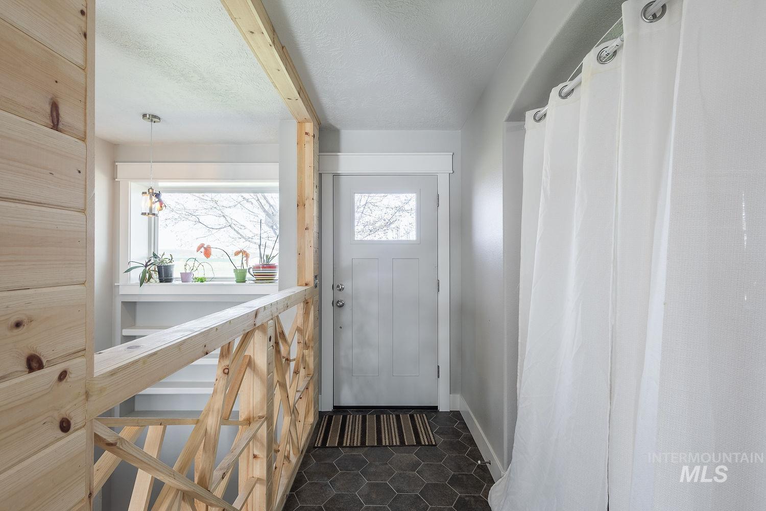 3950 Cassia Road New Plymouth, ID 83655 - Photo 22 of 26 Doorway featuring a textured ceiling and tile patterned flooring