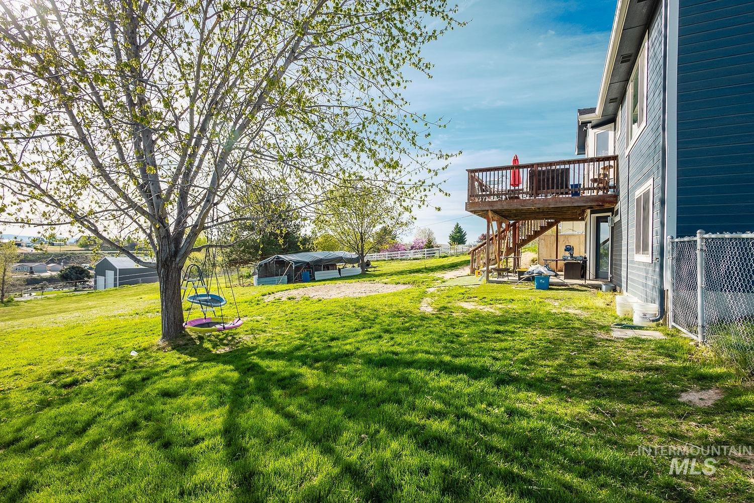 3950 Cassia Road New Plymouth, ID 83655 - Photo 23 of 26 Fenced yard featuring a deck and a patio