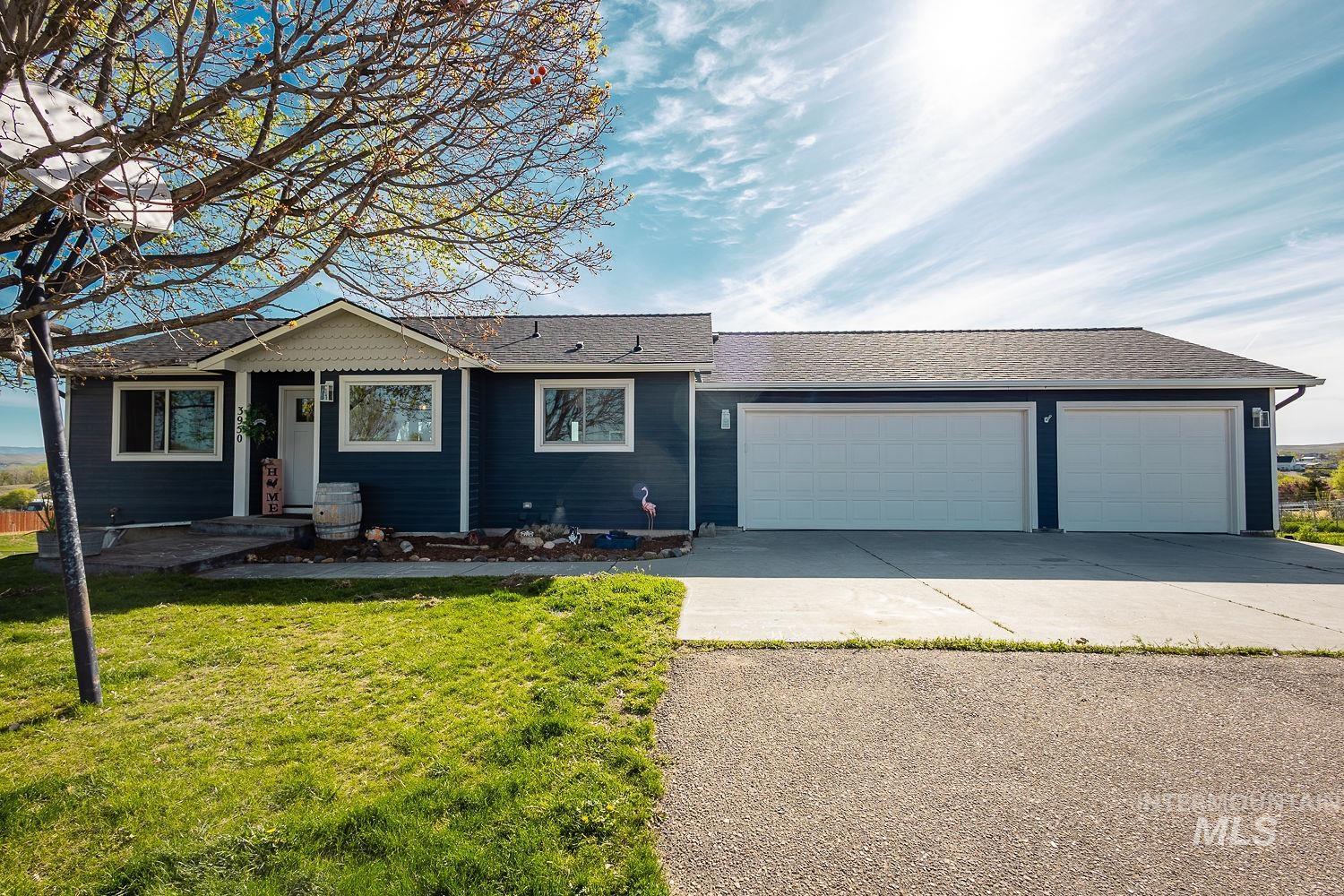 3950 Cassia Road New Plymouth, ID 83655 - Photo 26 of 26 Ranch-style home featuring a shingled roof, a garage, concrete driveway, and a front yard