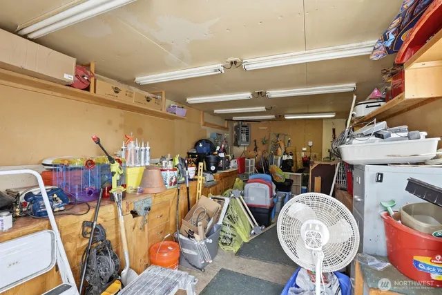 a view of a backyard with plants and brick wall