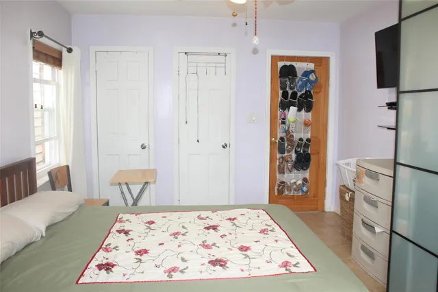 a bedroom with a bed and a window