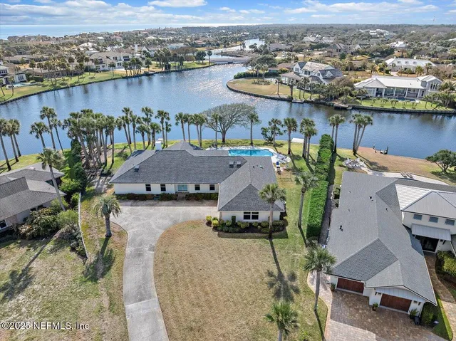 an aerial view of a house with a lake view