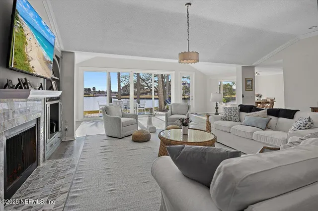 a living room with furniture a fireplace and a flat screen tv