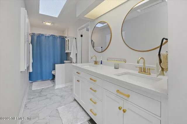 a bathroom with a sink double vanity and a mirror