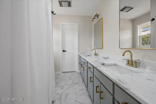 a bathroom with a double vanity sink and a mirror