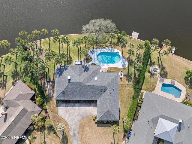 an aerial view of a house with a yard and a fountain