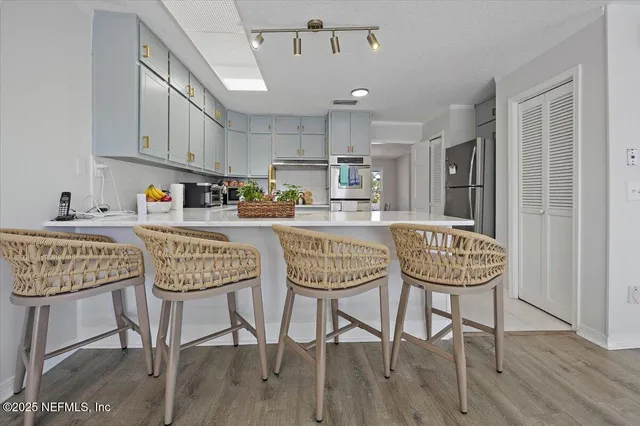 a dining room with furniture and wooden floor