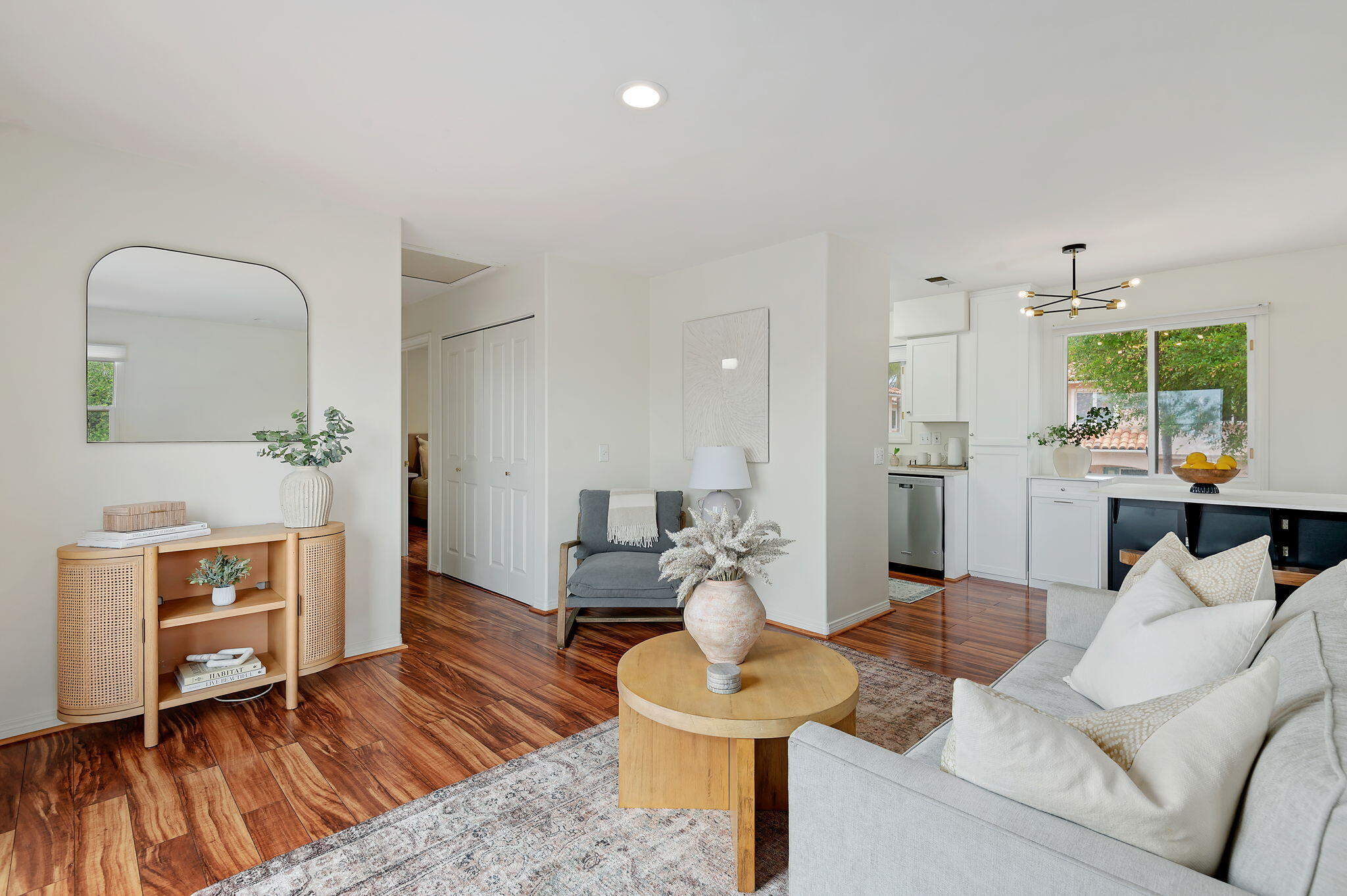 a living room with furniture and a wooden floor