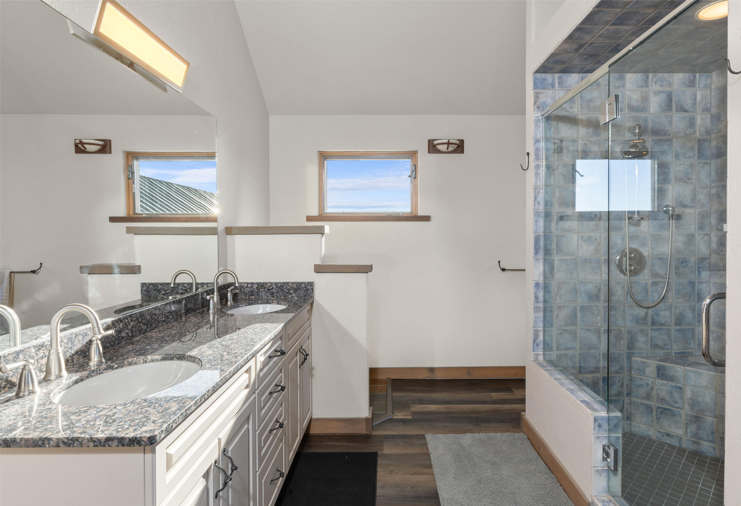541 Elam Ridge Drive Placerville, CO 81430 - Photo 21 of 36 a bathroom with a granite countertop double vanity sink a mirror and a bathtub