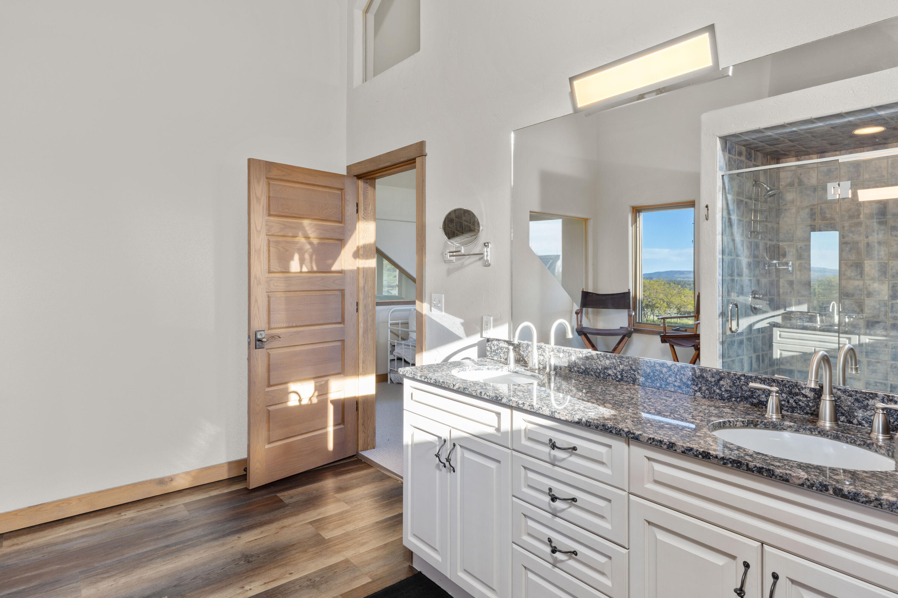 541 Elam Ridge Drive Placerville, CO 81430 - Photo 22 of 36 a bathroom with a granite countertop sink mirror and vanity