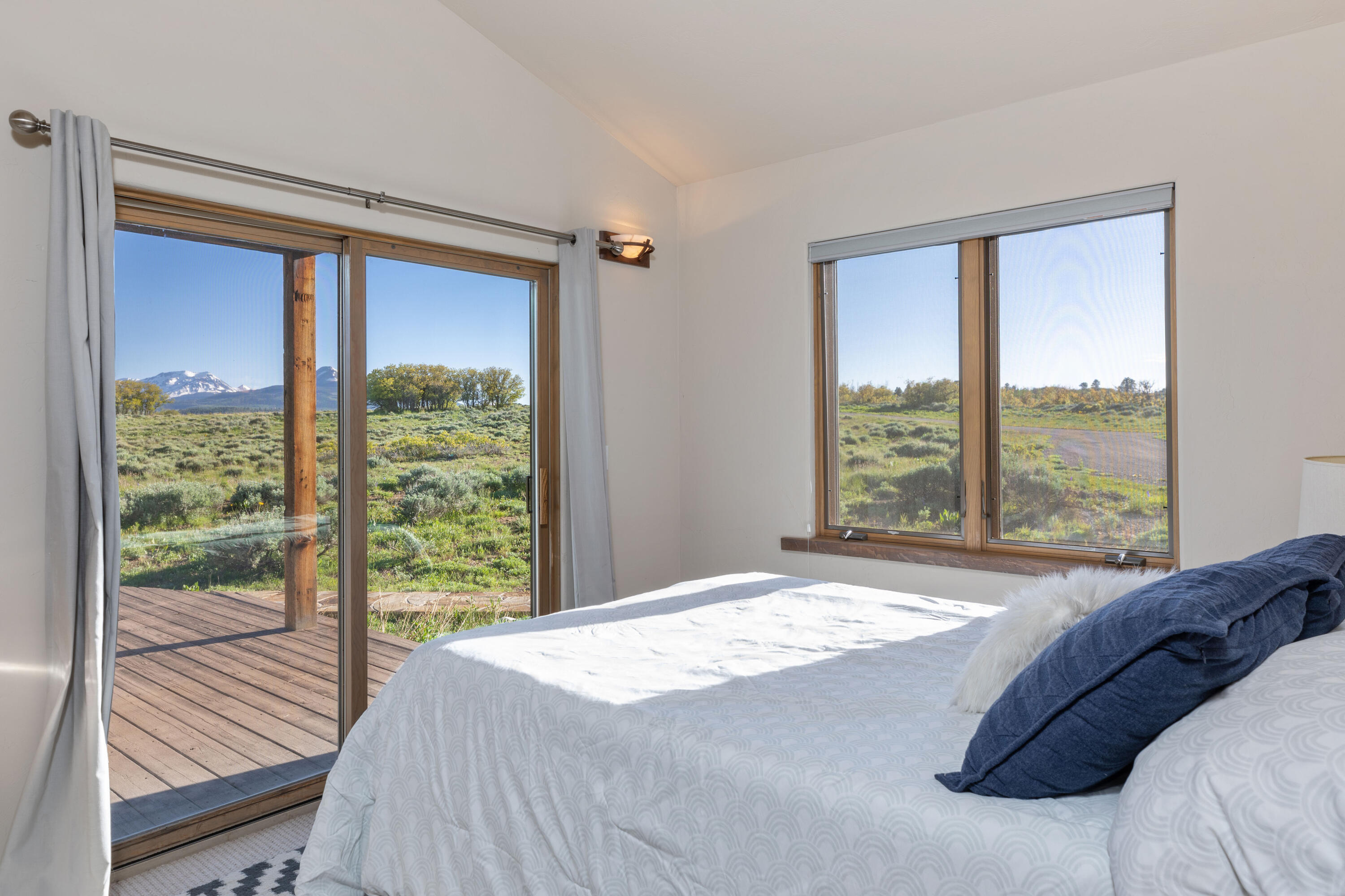 541 Elam Ridge Drive Placerville, CO 81430 - Photo 23 of 36 a bed sitting in a bedroom next to a window