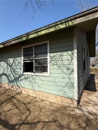 a backyard of a house with table and chairs
