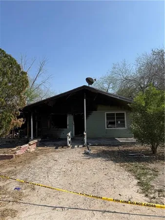 a view of house with a yard in the background