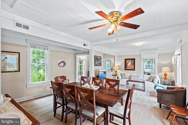 a kitchen with stainless steel appliances a stove a refrigerator and a chandelier