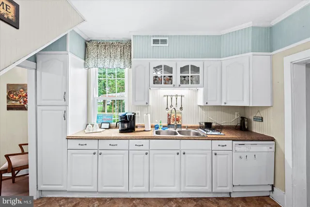 a kitchen with stainless steel appliances granite countertop a stove sink and cabinets