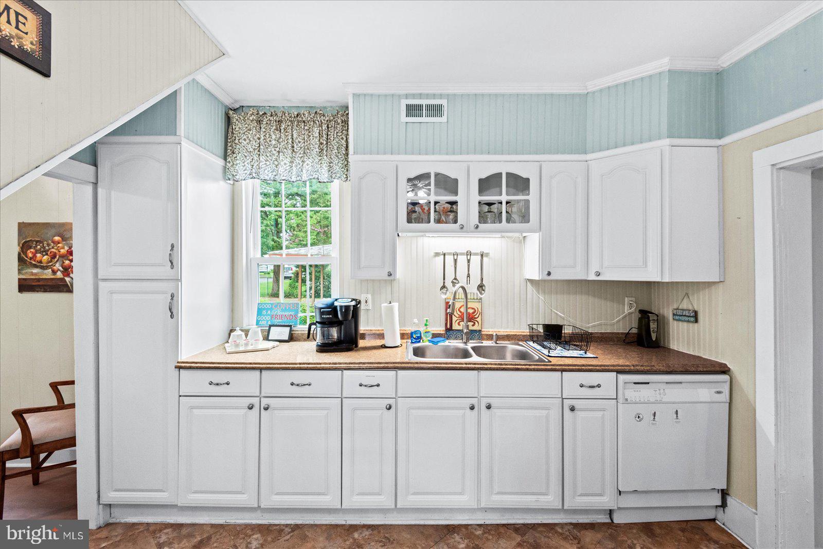 209 Hawthorn Street Colonial Beach, VA 22443 - Photo 17 of 56 a kitchen with cabinets appliances a sink and a window