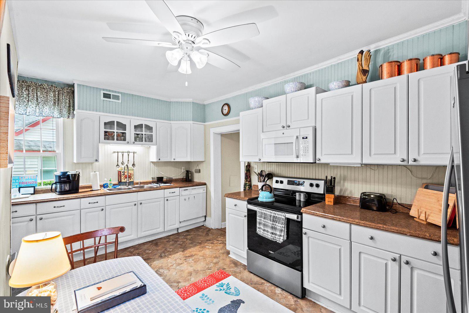 209 Hawthorn Street Colonial Beach, VA 22443 - Photo 18 of 56 a kitchen with stainless steel appliances granite countertop a stove sink and cabinets