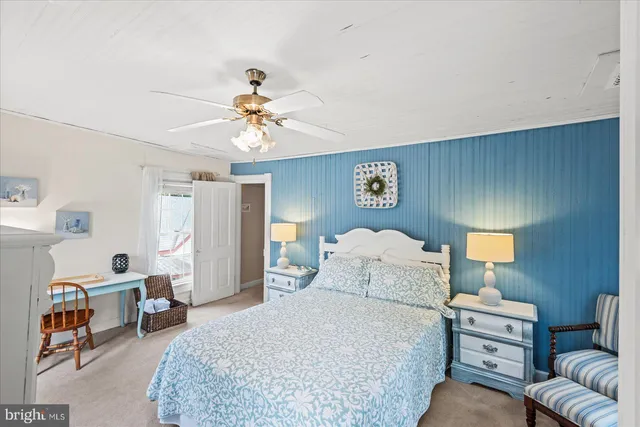 a spacious bedroom with a bed and a chandelier