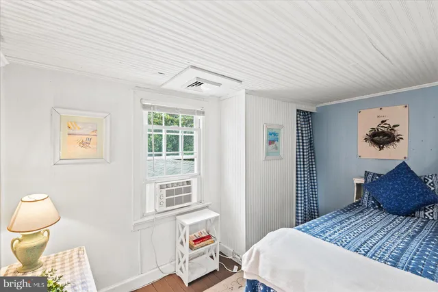 a view of bedroom with furniture and window