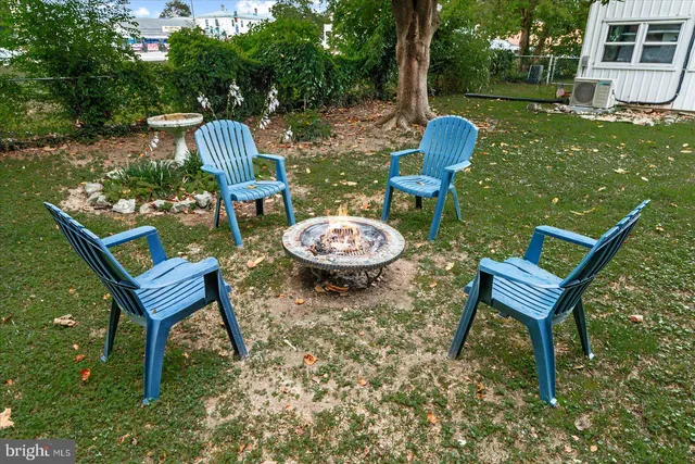 a view of a house with backyard and a tree