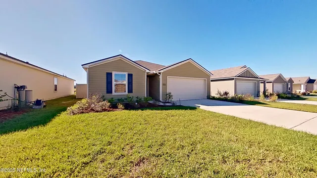 a front view of a house with a garden