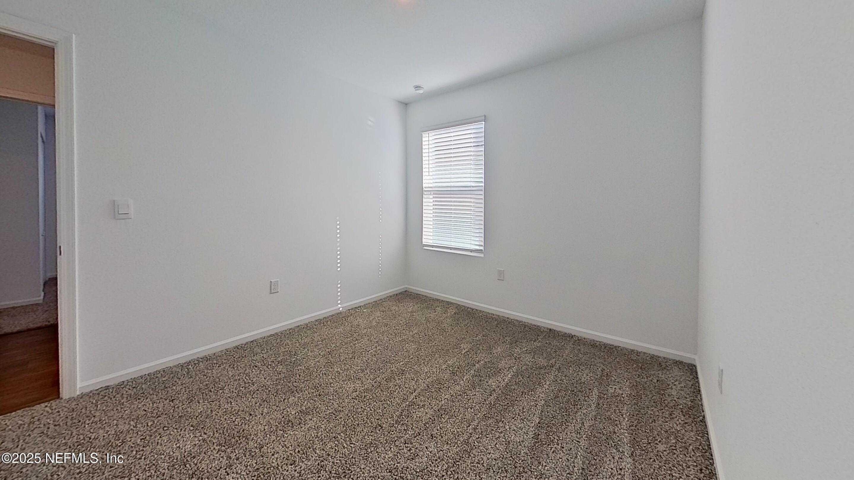 12452 Rubber Fig Terrace Jacksonville, FL 32218 - Photo 11 of 25 an empty room with windows