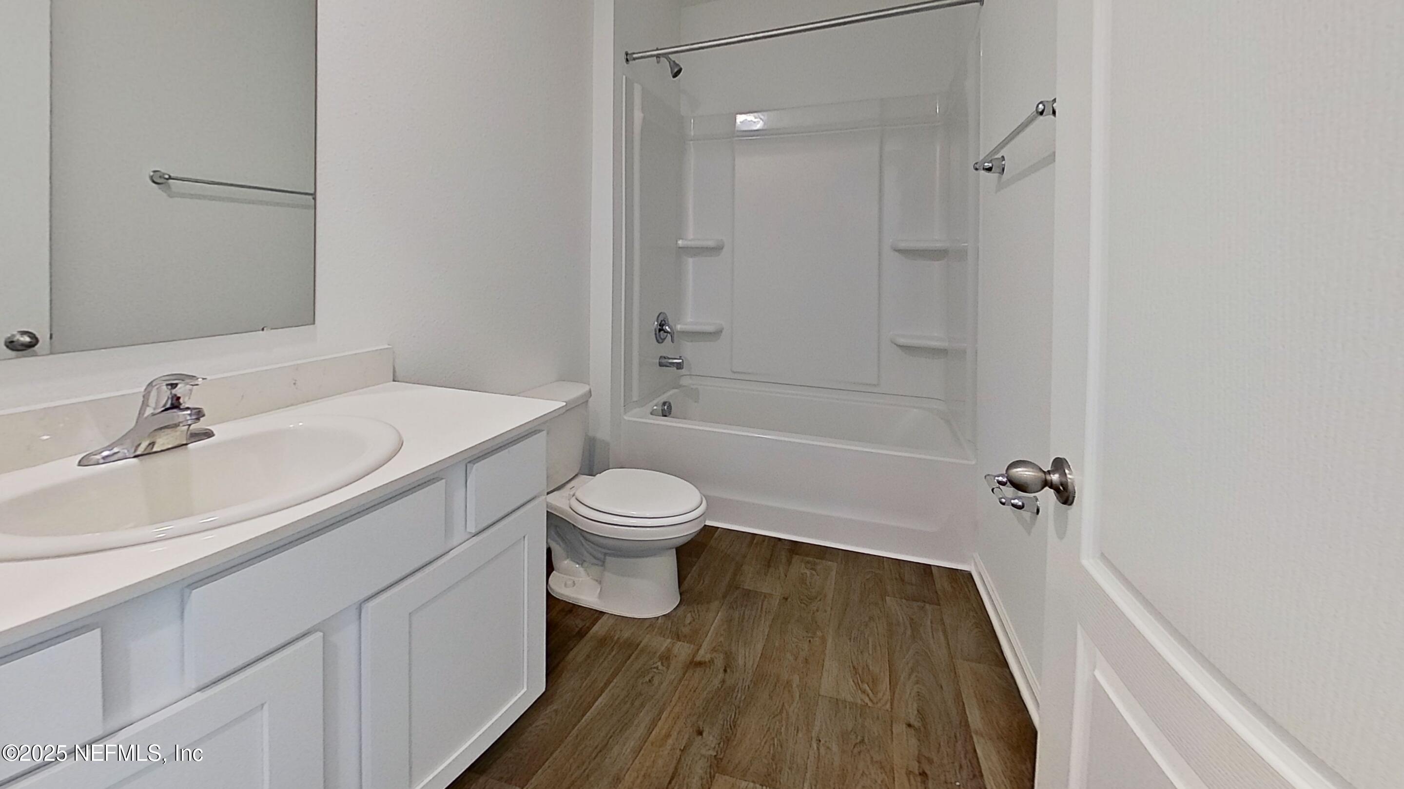 12452 Rubber Fig Terrace Jacksonville, FL 32218 - Photo 13 of 25 a bathroom with a sink a toilet and shower