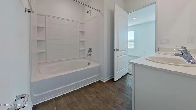 a bathroom with a bathtub and a sink