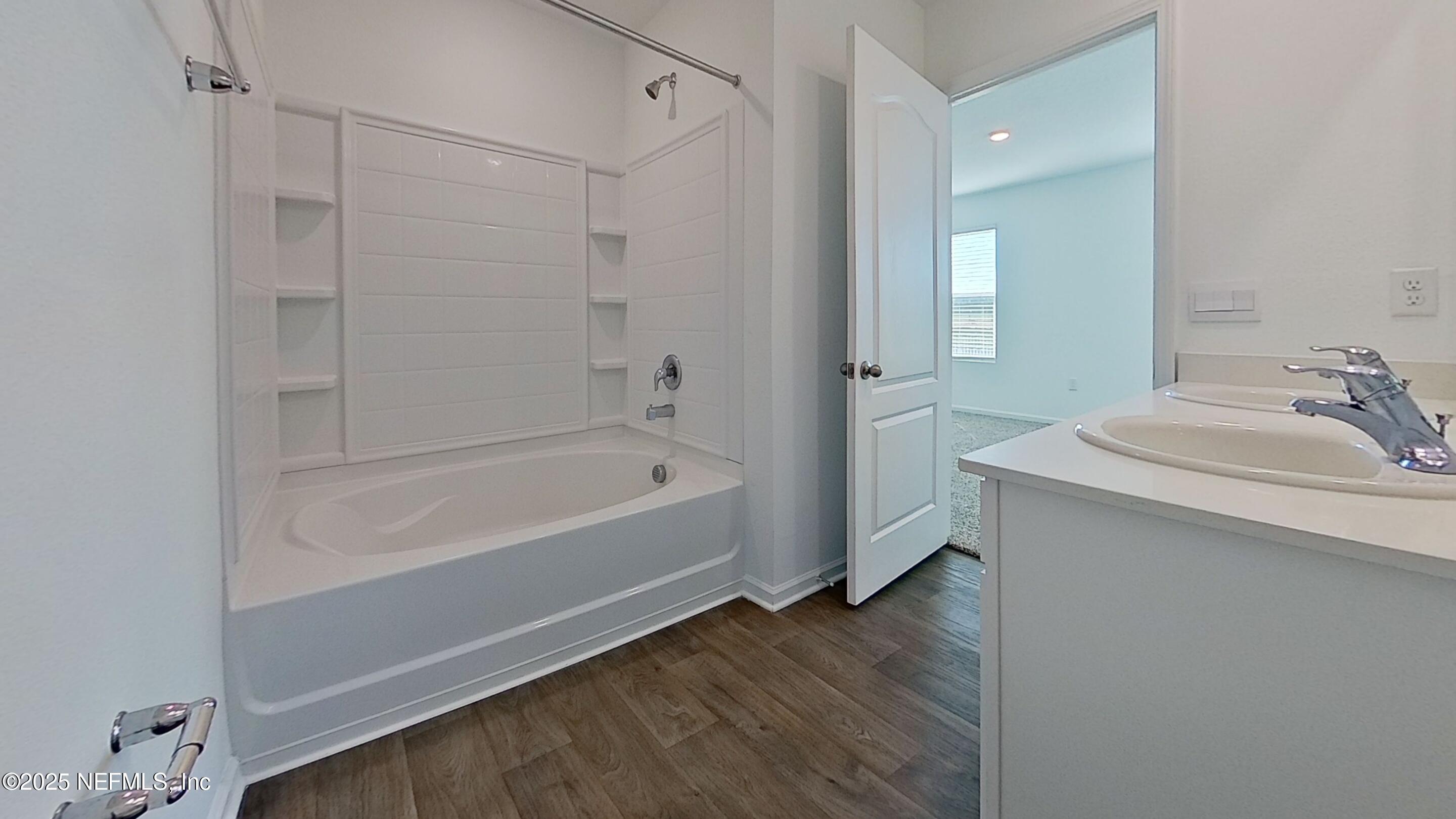 12452 Rubber Fig Terrace Jacksonville, FL 32218 - Photo 16 of 25 a bathroom with a bathtub and a sink