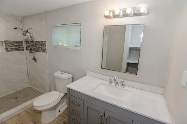 a bathroom with a sink toilet and shower