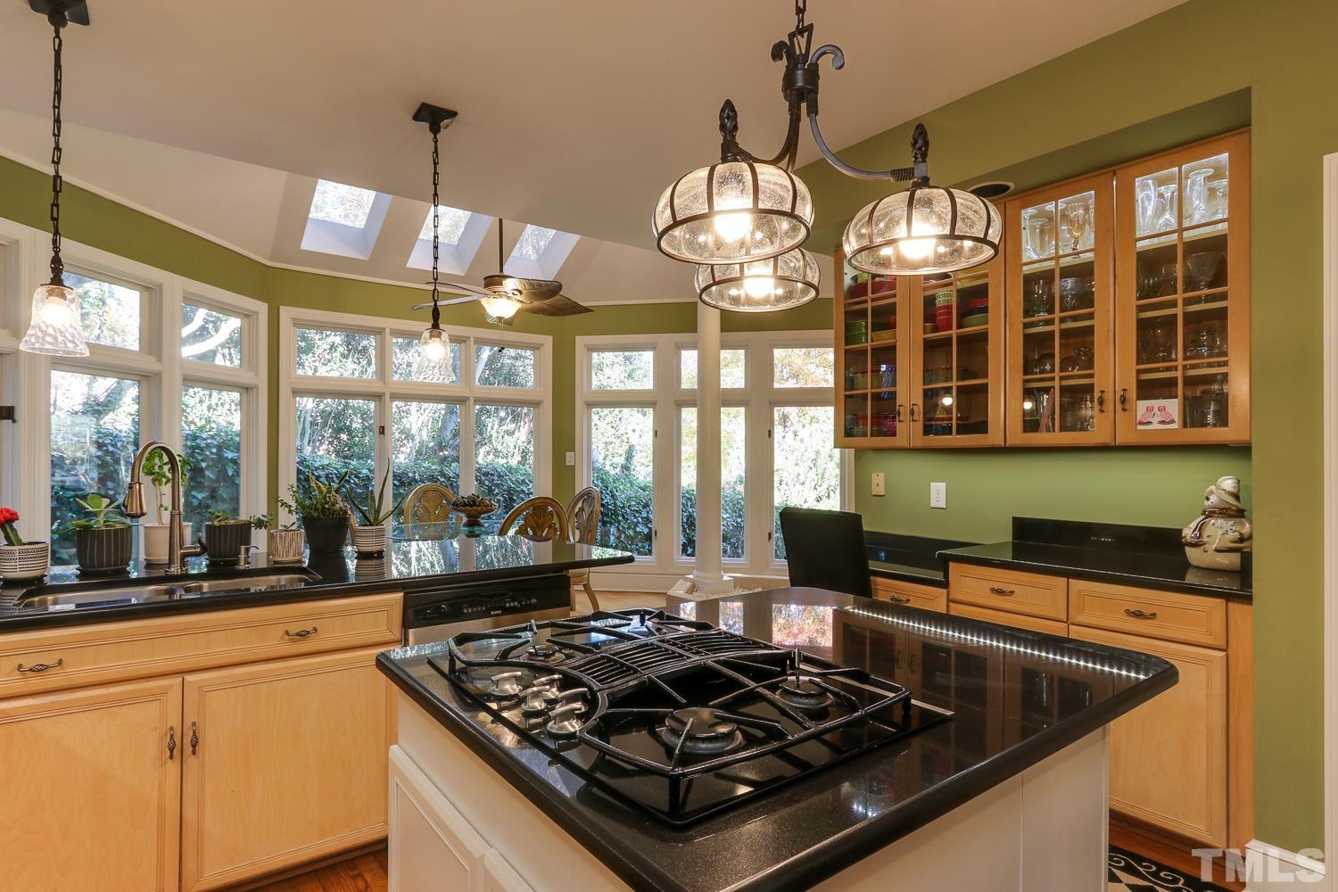 6921 Valley Ridge Court Raleigh, NC 27615 - Photo 14 of 27 a kitchen with stainless steel appliances granite countertop a stove and a sink