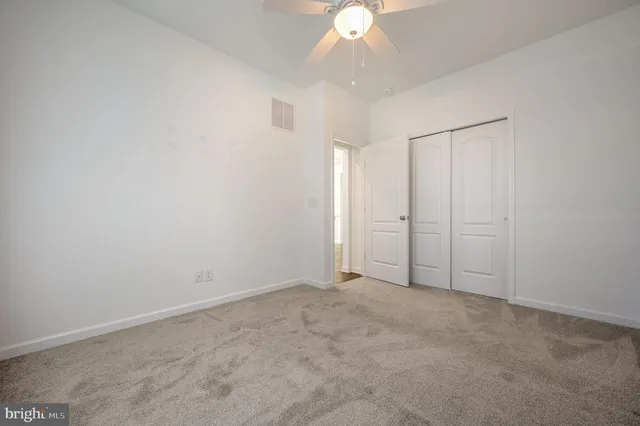 an empty room with a empty space and a ceiling fan