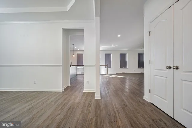 a view of a kitchen with wooden floor and a refrigerator