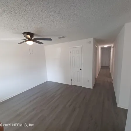 a view of a room with wooden floor