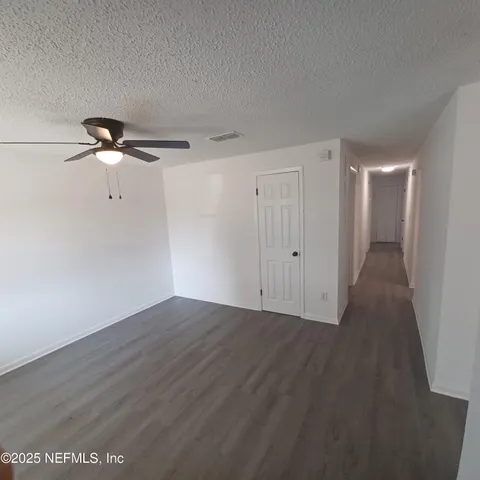 a view of a room with wooden floor
