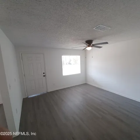 a view of an empty room and a window