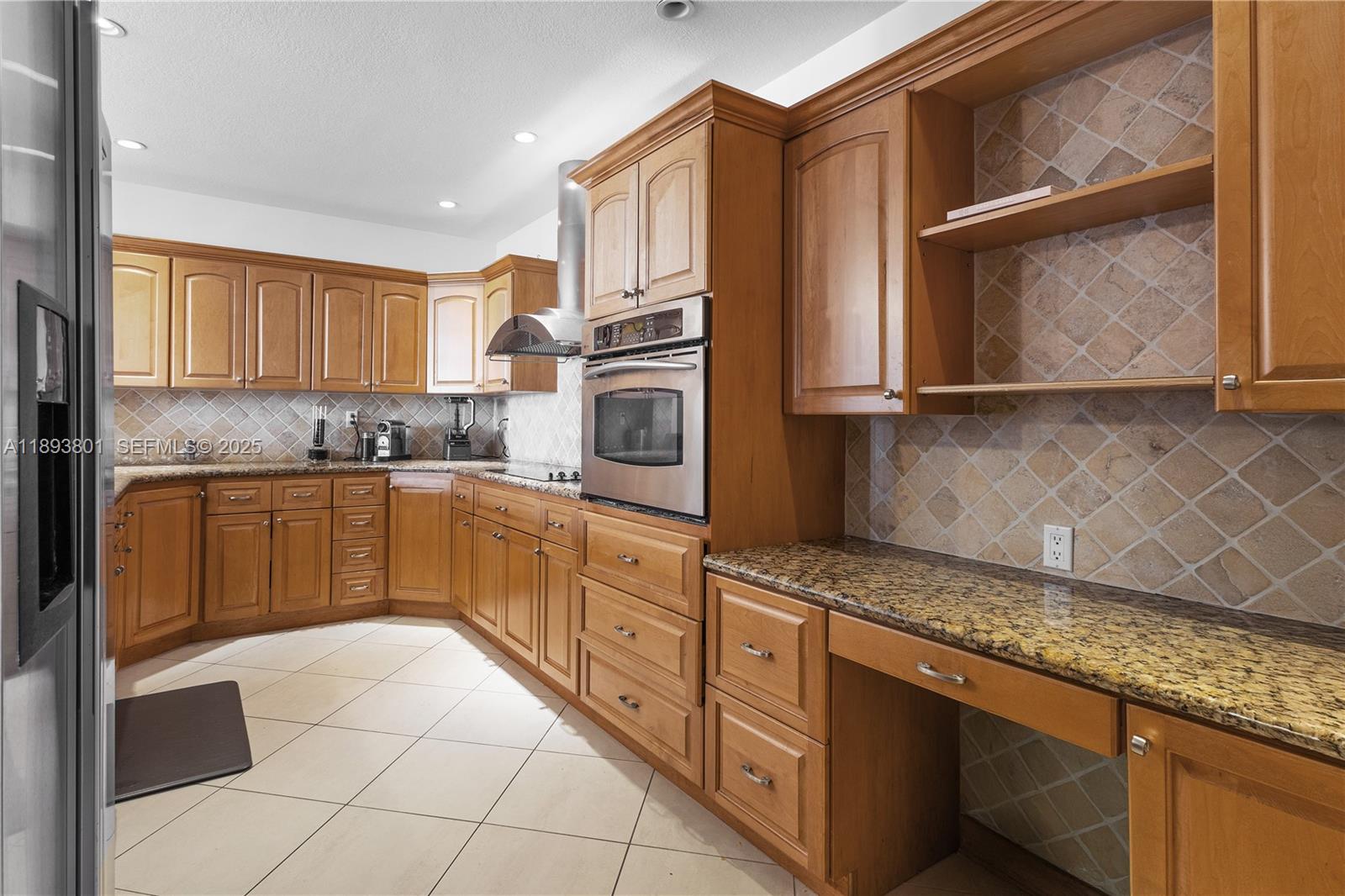 251 Crandon Boulevard, Unit 441 Key Biscayne, FL 33149 - Photo 13 of 28 a kitchen with stainless steel appliances granite countertop a sink stove and cabinets