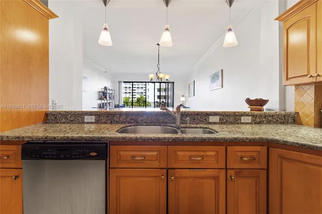 a kitchen with granite countertop kitchen island and stainless steel appliances