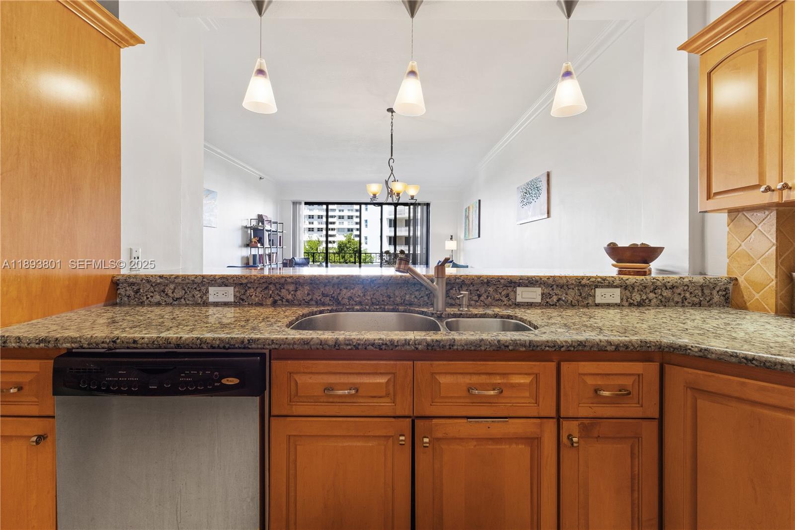 251 Crandon Boulevard, Unit 441 Key Biscayne, FL 33149 - Photo 15 of 28 a kitchen with granite countertop kitchen island and stainless steel appliances