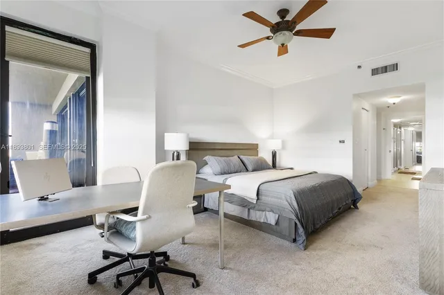 a spacious bedroom with a bed and a chandelier