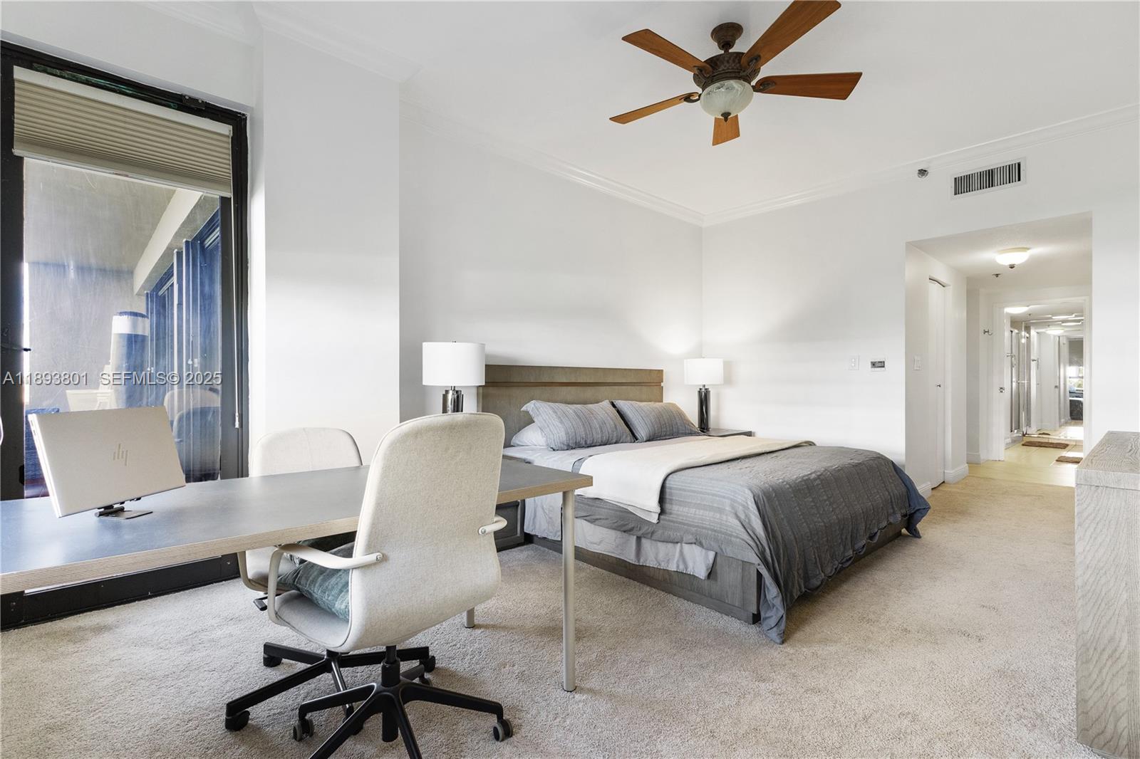 251 Crandon Boulevard, Unit 441 Key Biscayne, FL 33149 - Photo 17 of 28 a spacious bedroom with a bed and a chandelier