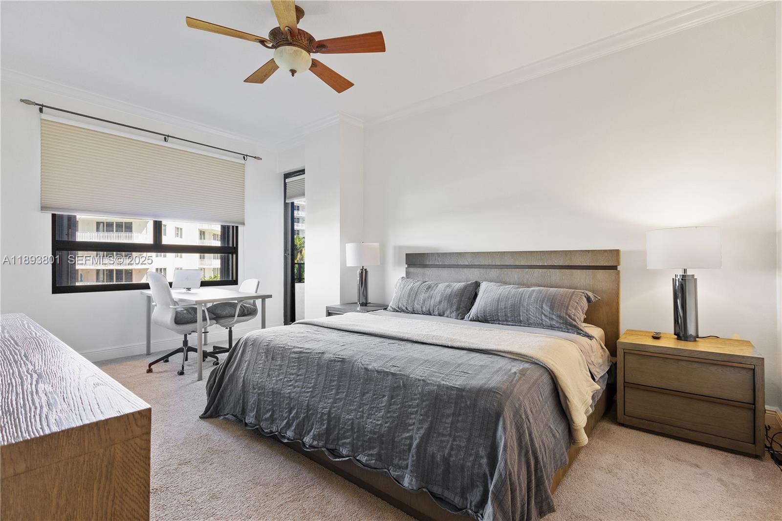 251 Crandon Boulevard, Unit 441 Key Biscayne, FL 33149 - Photo 18 of 28 a bedroom with a bed and a chandelier