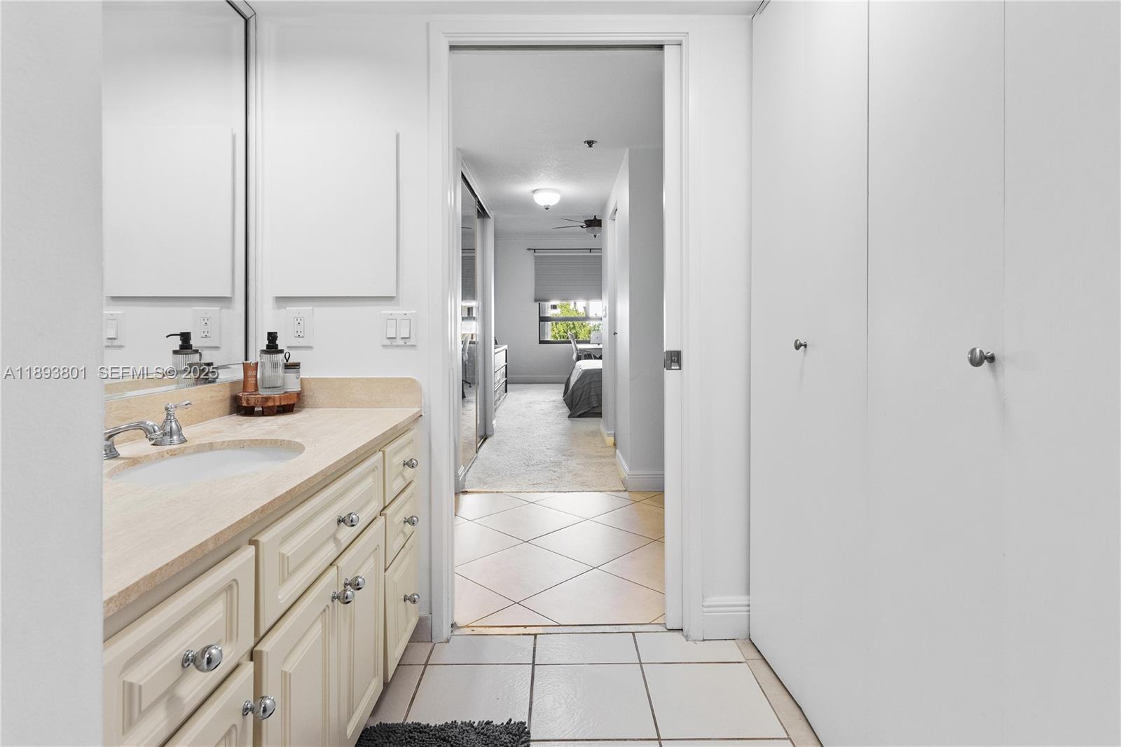251 Crandon Boulevard, Unit 441 Key Biscayne, FL 33149 - Photo 20 of 28 a spacious bathroom with a double vanity sink and a mirror