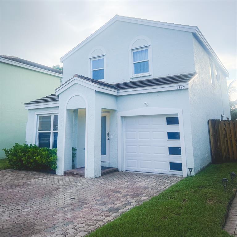 3329 Apache Lane Margate, FL 33063 - Photo 1 of 5 a view of a white house with a yard and garage
