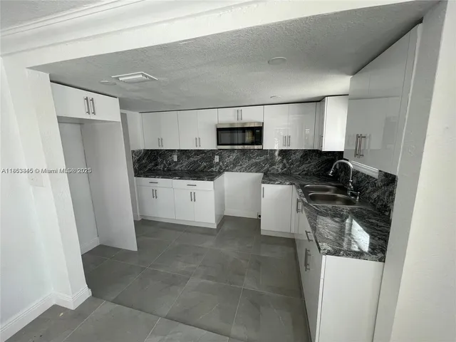 a kitchen with a sink a stove and refrigerator