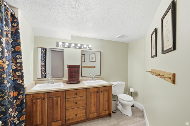 353 Robin Street Smithfield, UT 84335 - Photo 38 of 70 Bathroom featuring double vanity and a textured ceiling
