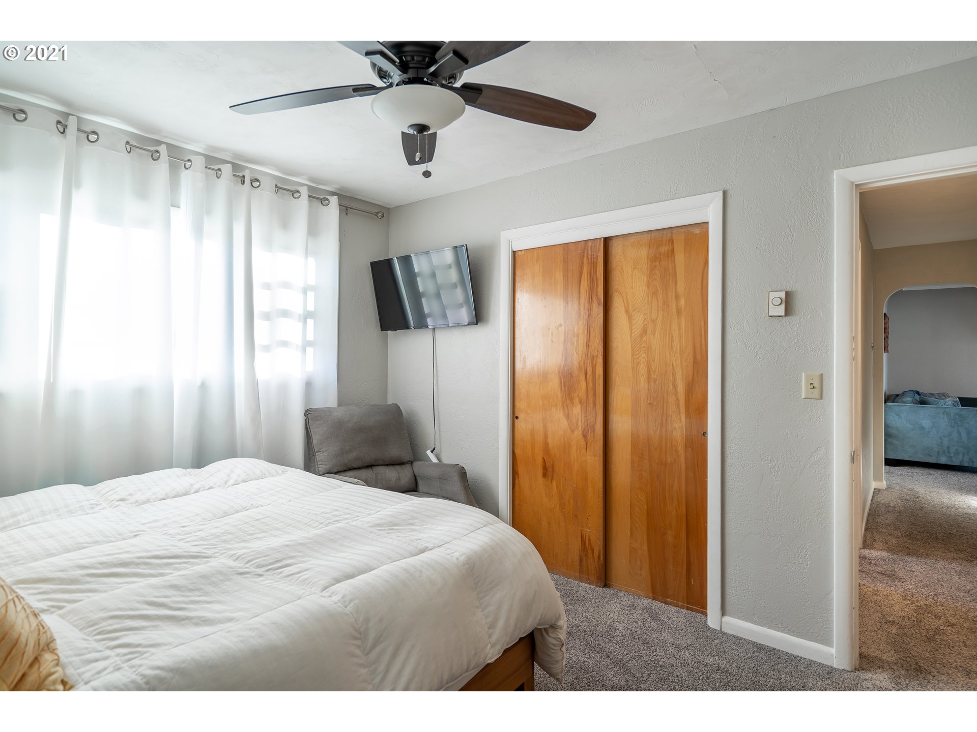1367 Olympic Street Springfield, OR 97477 - Photo 11 of 20 a bedroom with a large bed and a chandelier