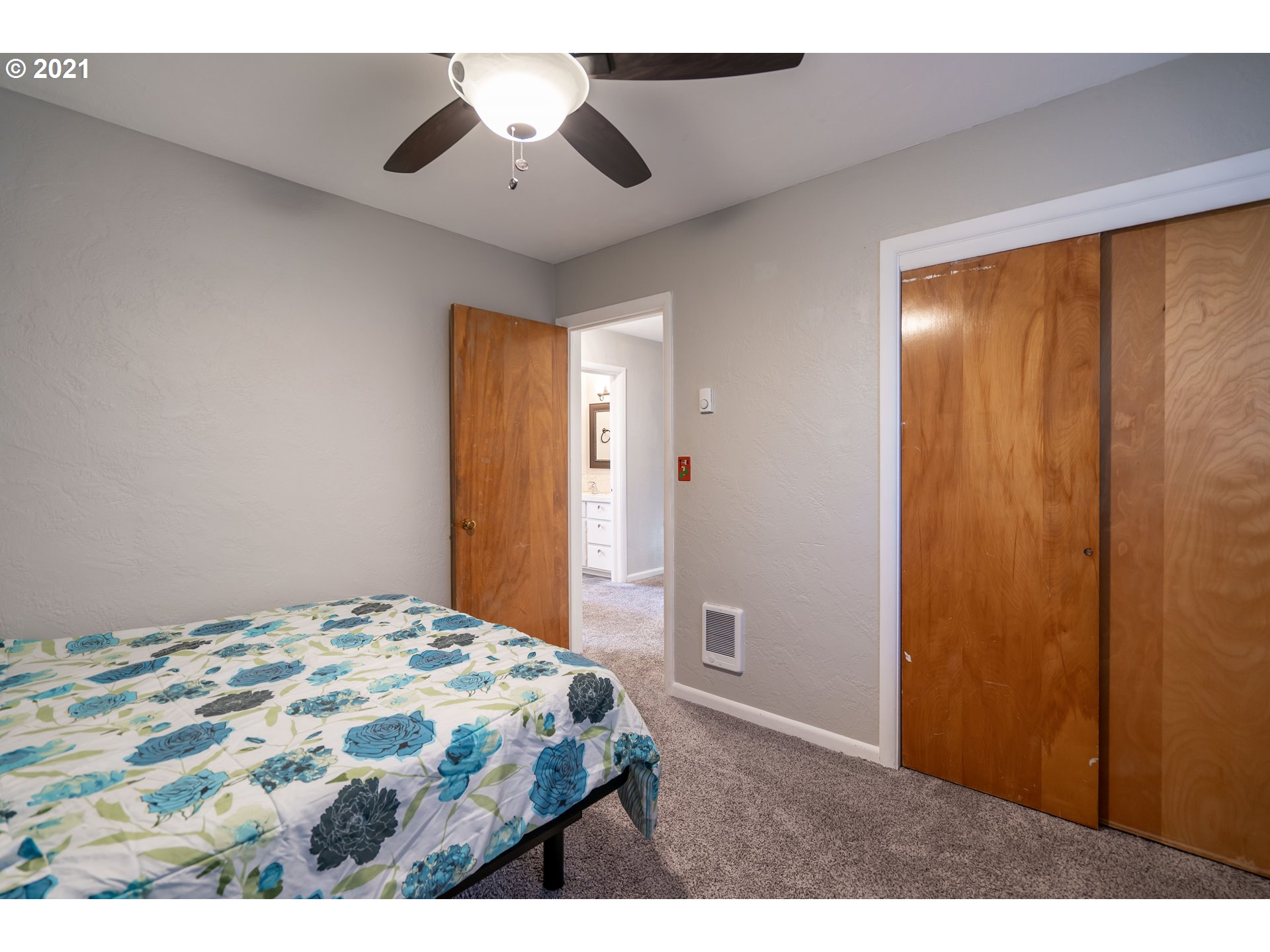 1367 Olympic Street Springfield, OR 97477 - Photo 13 of 20 a bedroom with a bed and a chandelier