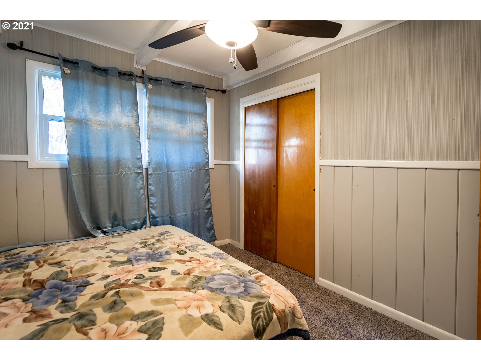 1367 Olympic Street Springfield, OR 97477 - Photo 14 of 20 a bedroom with a bed and a chandelier